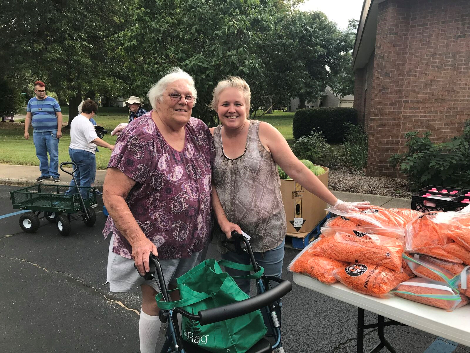 Nelda and her daughter smiling at a mobile food pantry