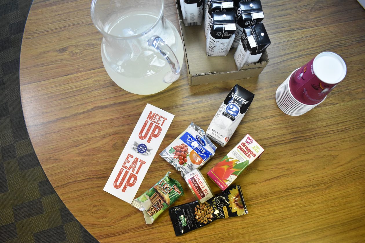 An assortment of food sits on a table at a Meet Up & Eat Up site.