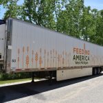 A reefer (back part of a truck) with the food bank's logo on it awaits loading.