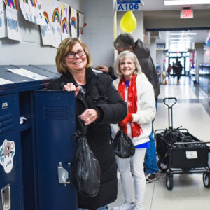 volunteers put lunch bags in kids' lockers