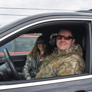 Two clients sitting in car smiling