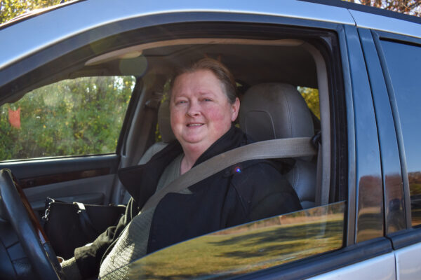 Woman smiling in her car at Mobile Pantry