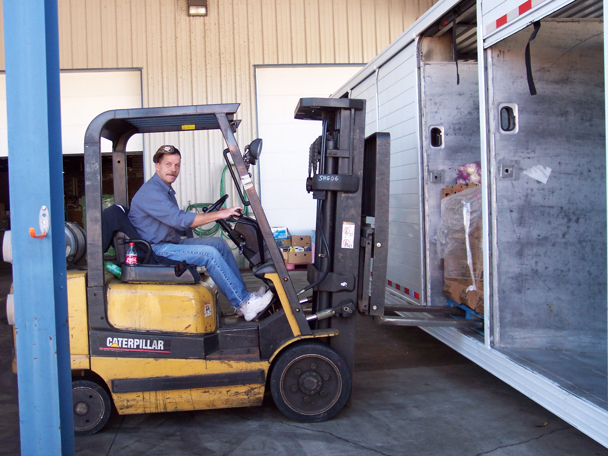 Mike Ward, longtime staffer, drives a hi-lo