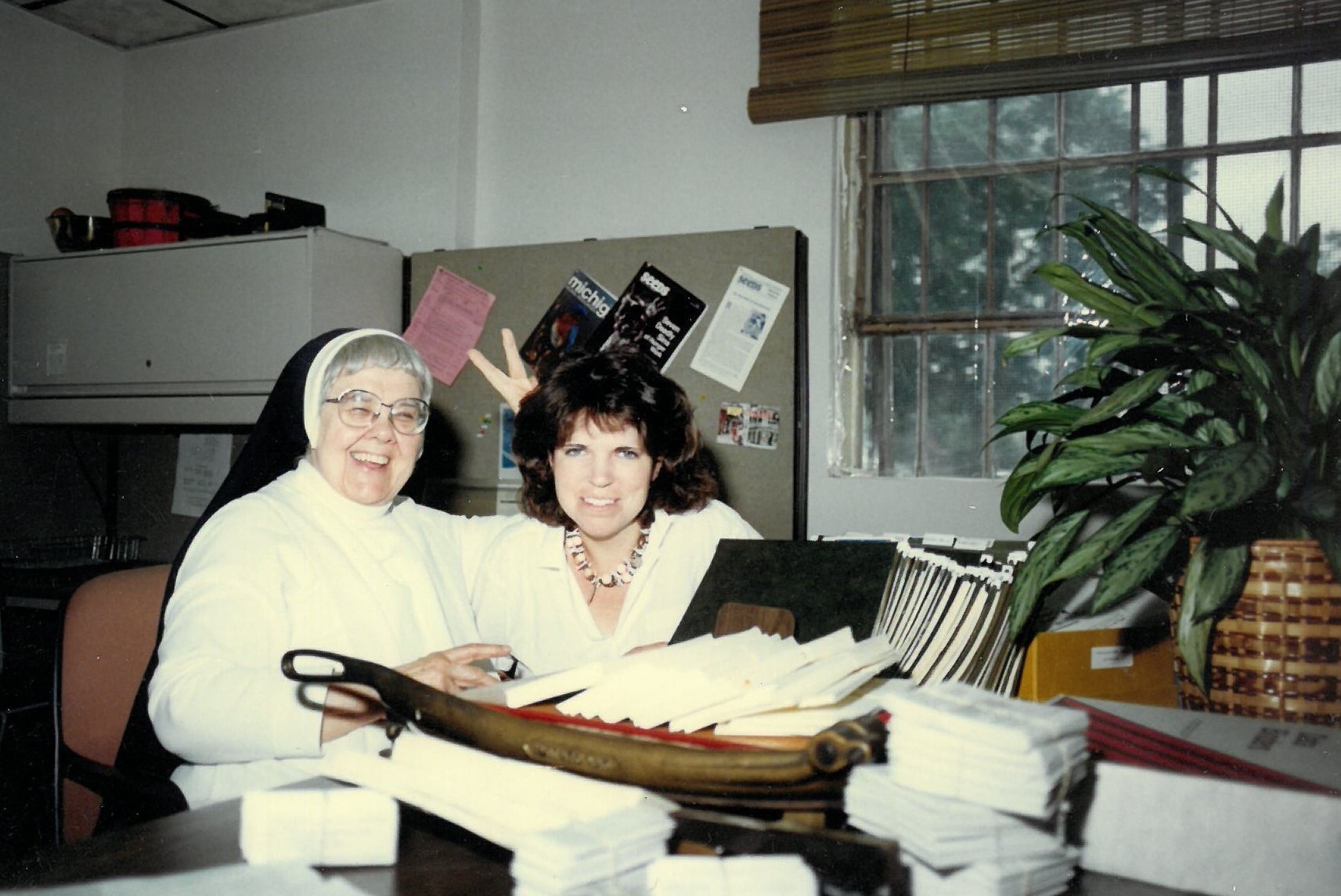 Sister Rose, a long time volunteer, and an unknown staff member
