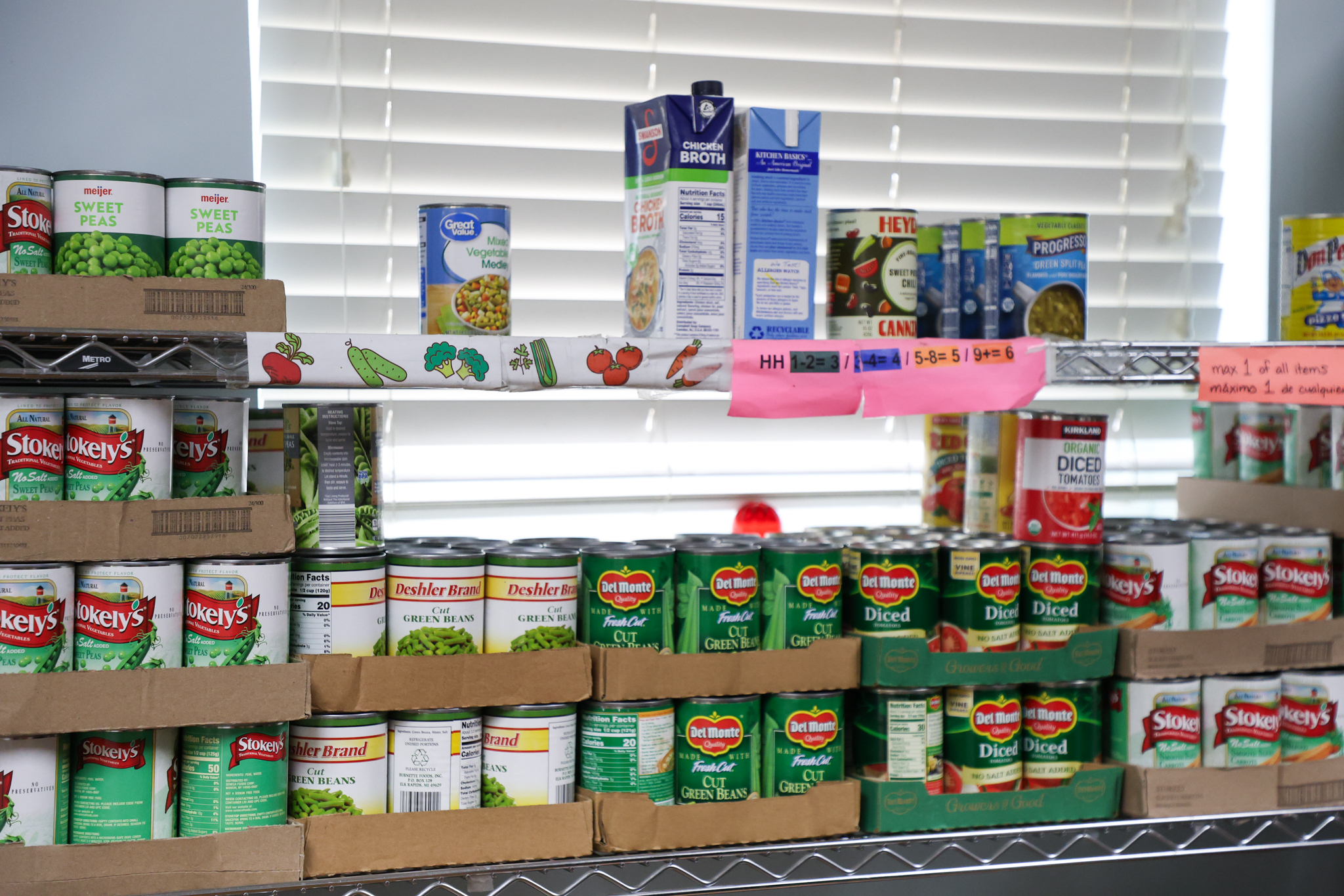 Several metal racks with canned products.