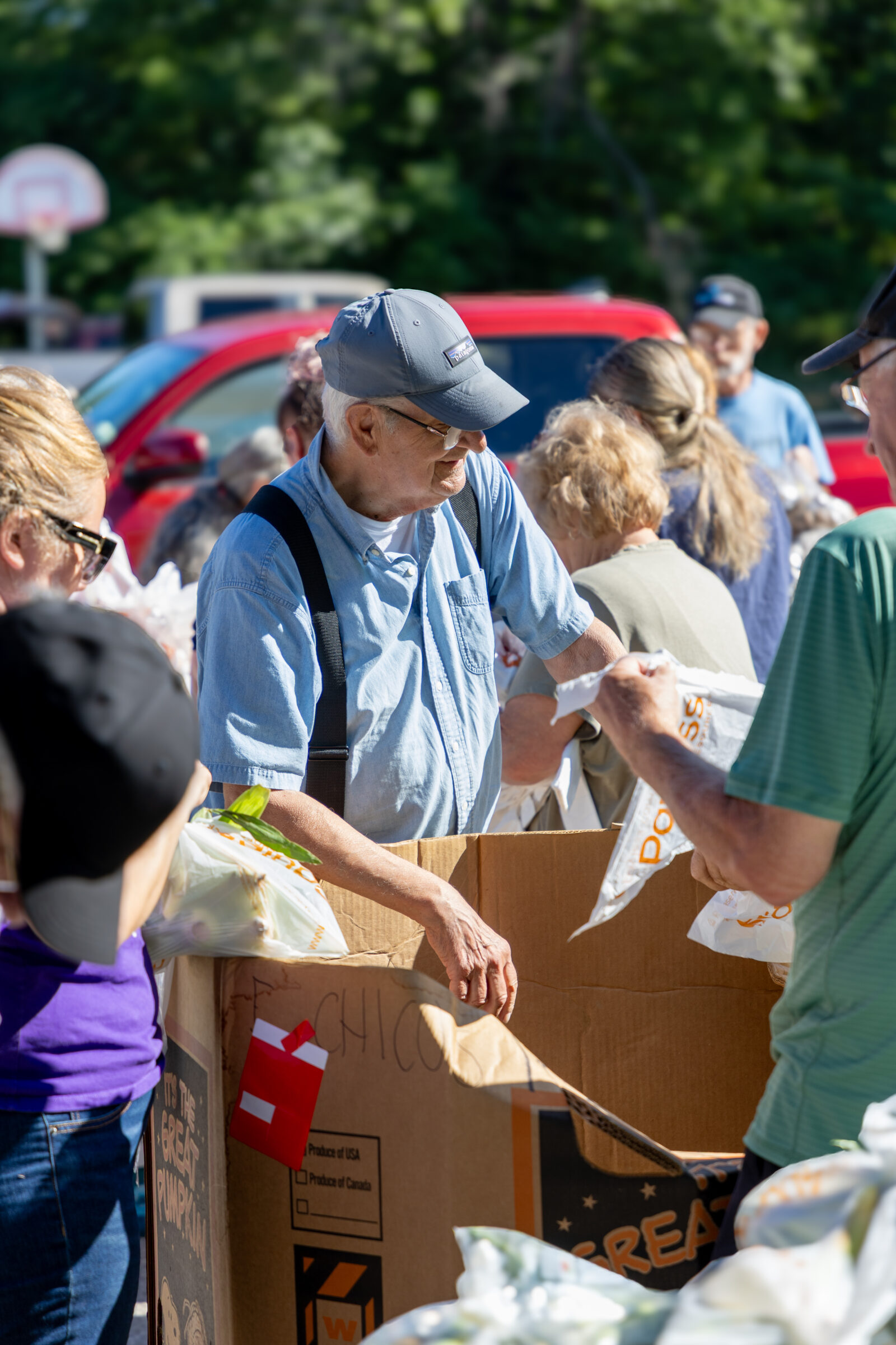 Smiling volunteer at a mobile food pantry at Discovering Christ Church.