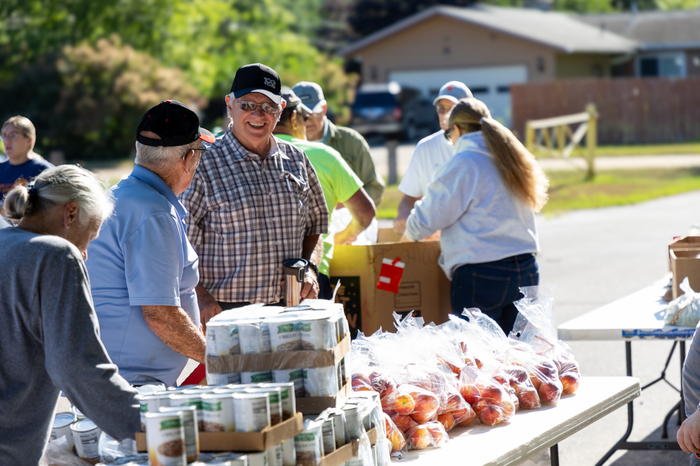 Smiling volunteer at Discovering Christ Church mobile food pantry
