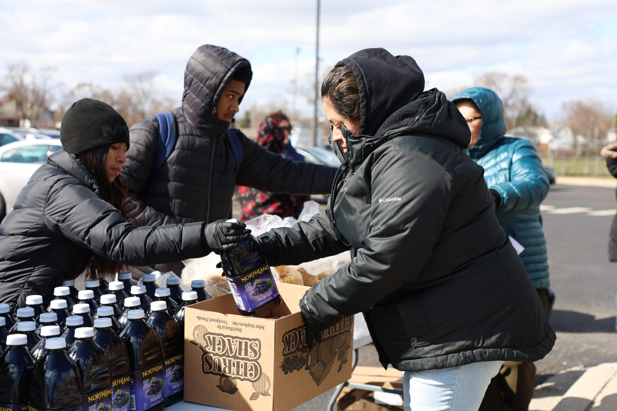 Volunteers of the Godfrey Lee Public School mobile food pantries package food items into boxes for neighbors. 