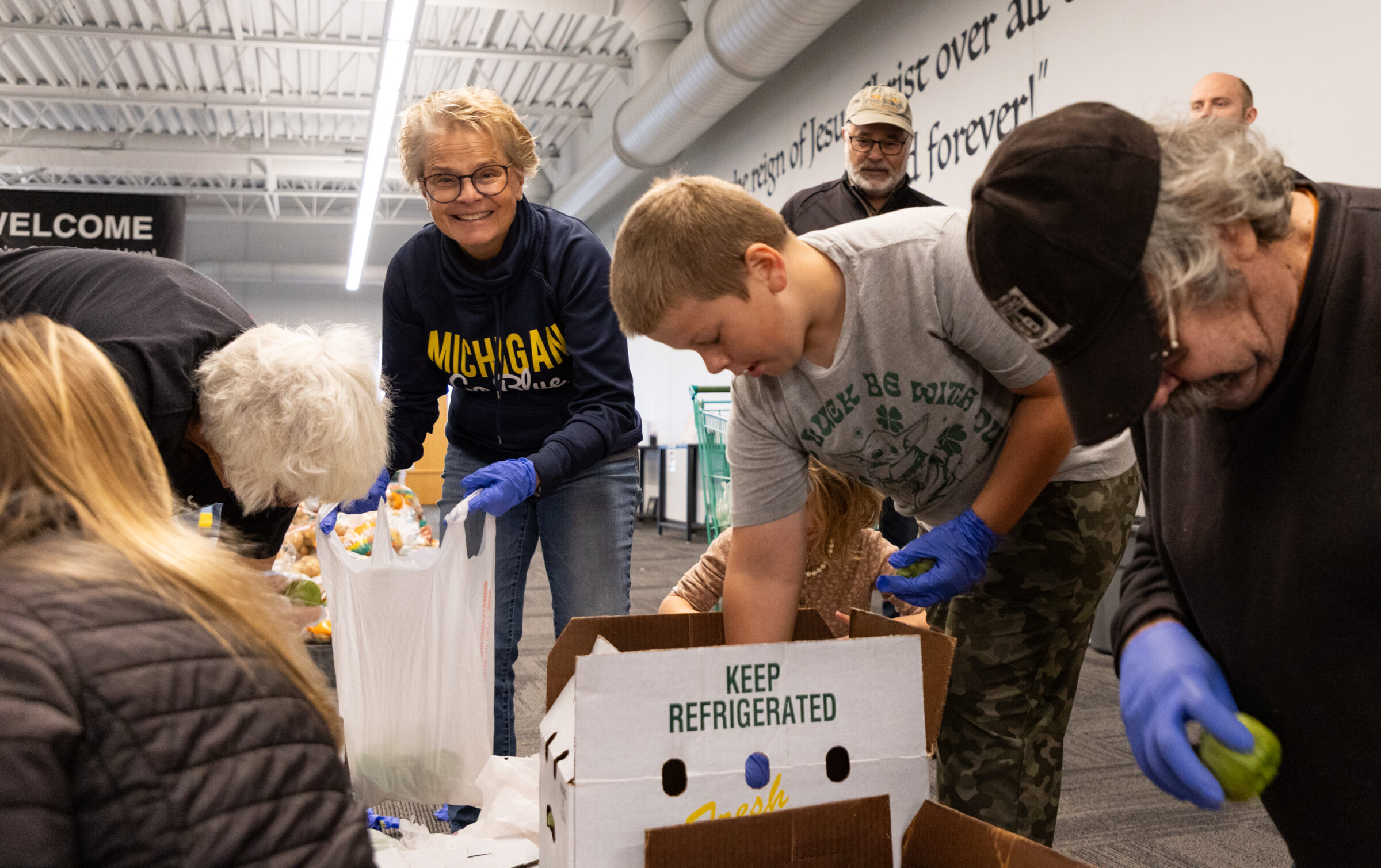 Volunteers work together to package nutritious food items for 125 households in Ottawa County. 