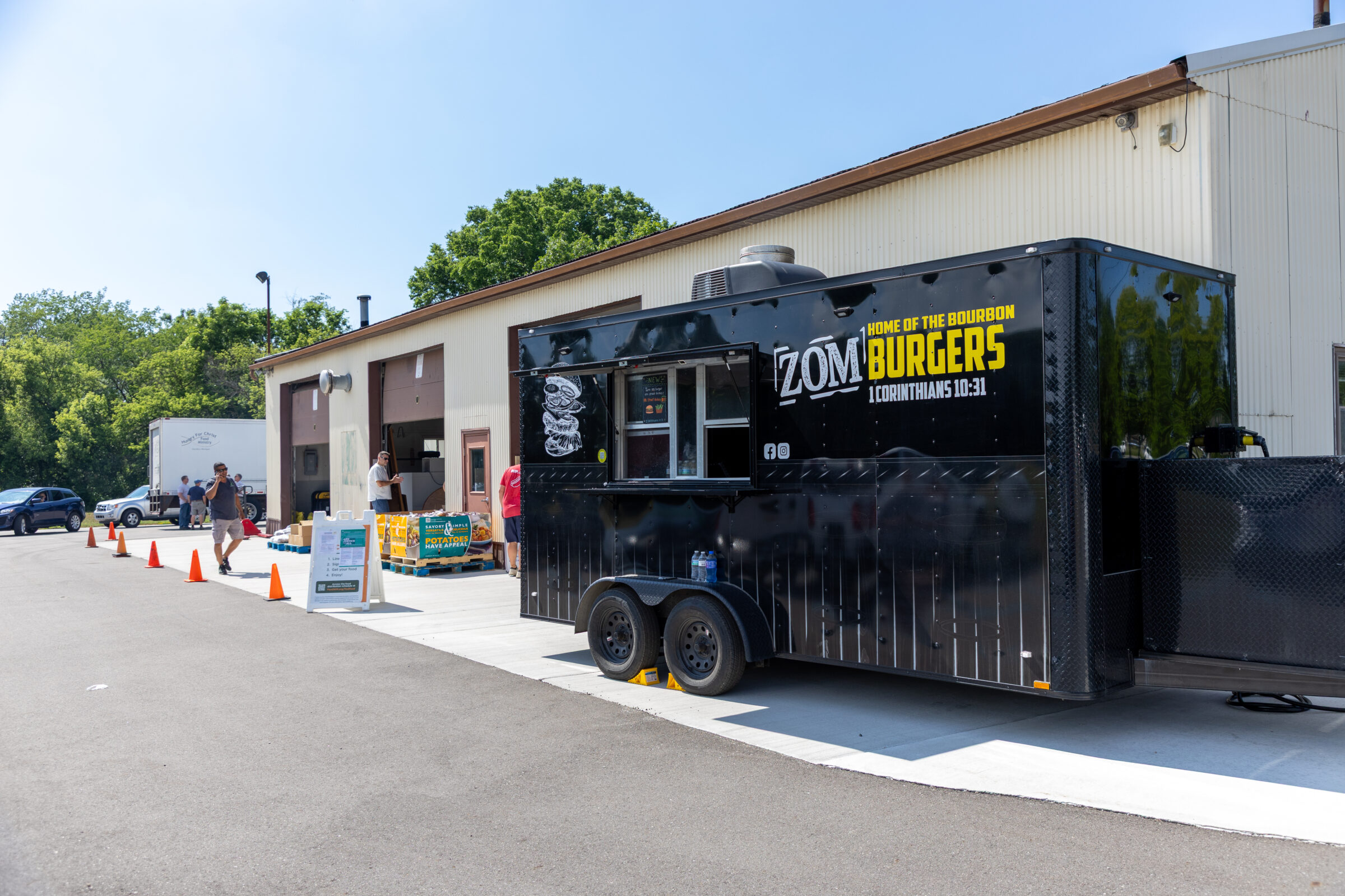 Local food truck ZOMburgers offers cooked meals to neighbors in attendance.