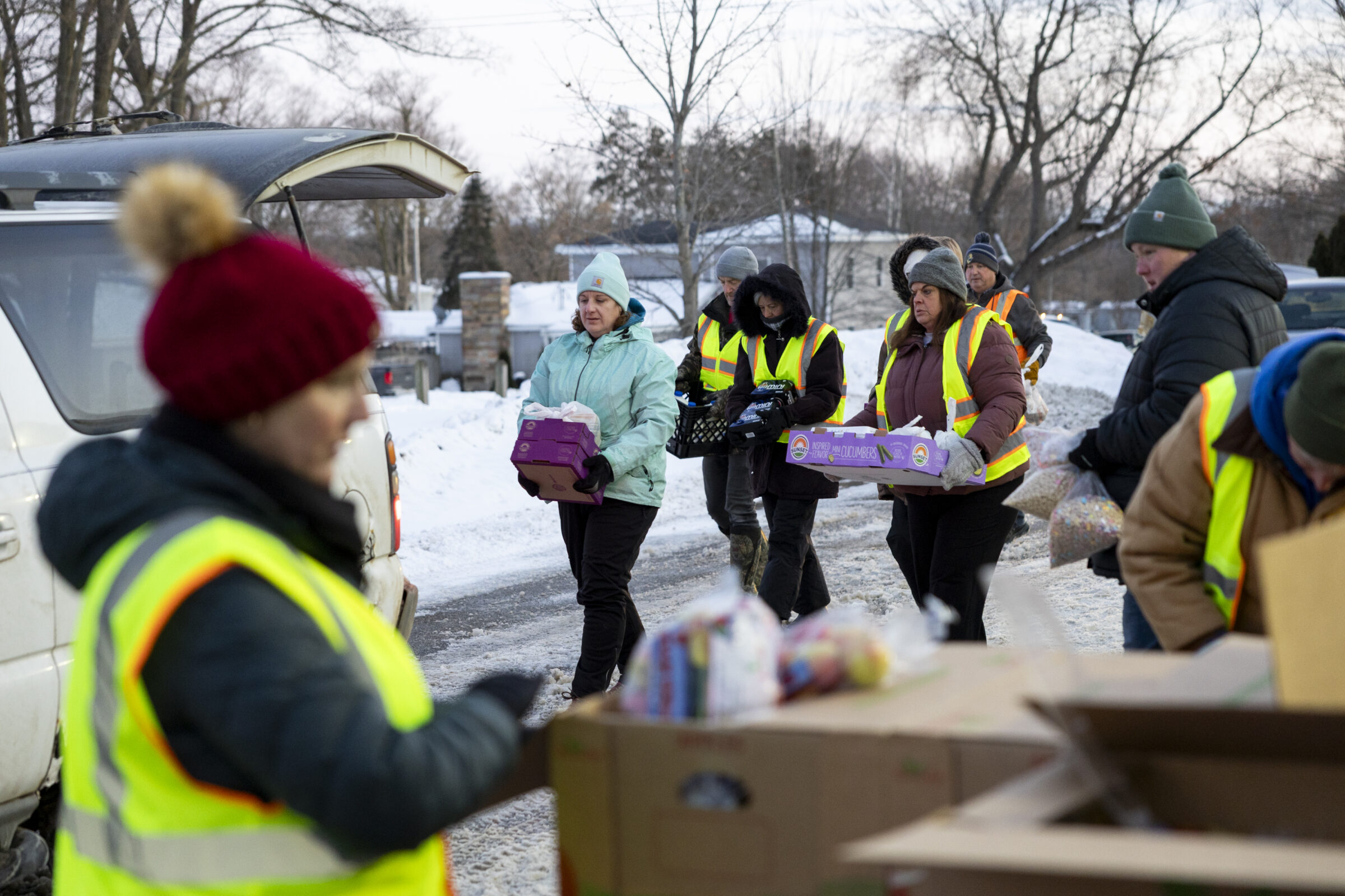 Mobile food pantry volunteers at Twin Rivers Elementary School in Muir load up neighbor cars with nutritious food. 