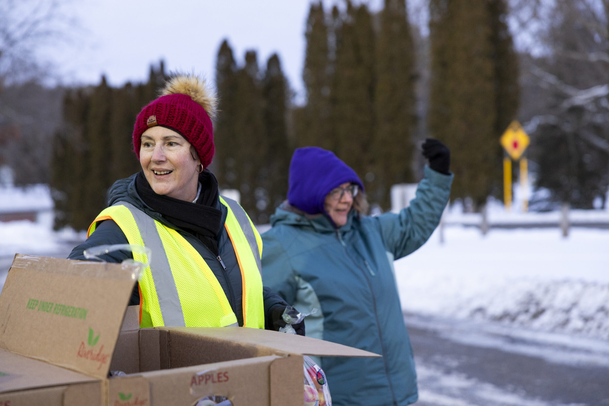 Mobile food pantry coordinator Wanda Zenk alongside another volunteer at a mobile food pantry in Muir. 