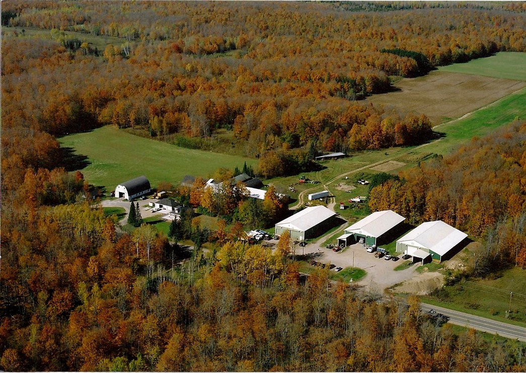 Johnson Brothers Inc. Farm top view surrounded by woods. 