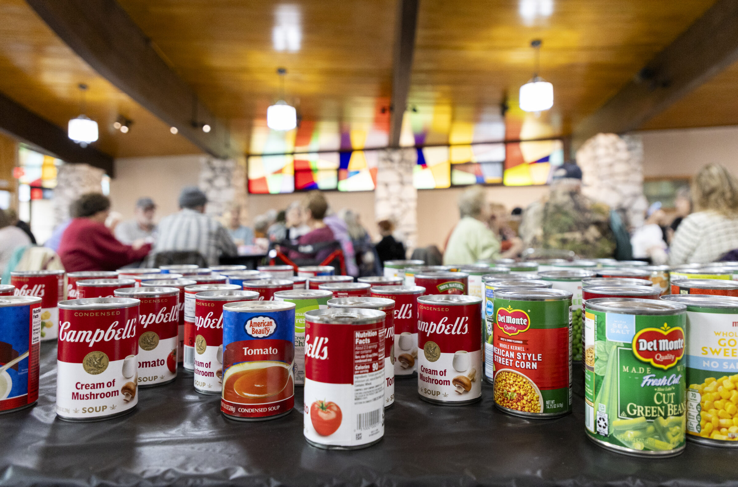 Rows of canned food like soups and vegetables. 