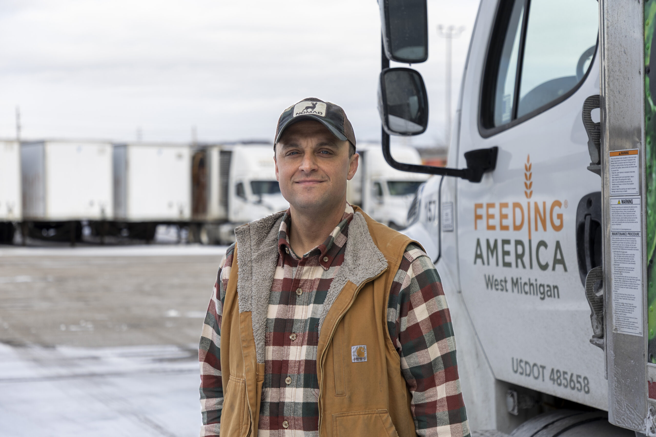 Feeding America West Michigan employee Ryan standing by a food bank truck.